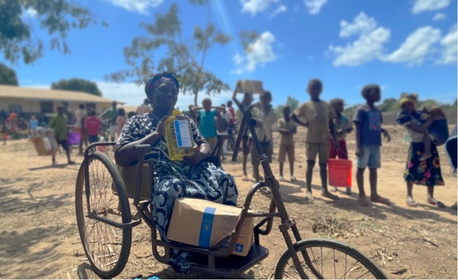 Woman in a wheelchair with food provisions in Mozambique