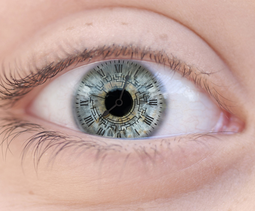 close up photo of a human eye with a clock superimposed on the iris