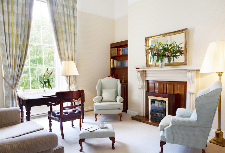 Two fireside chairs fireplace bookcase mirror desk with leather chair two lamps wall mirror