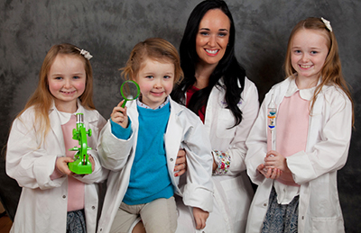 Tracey Jane Cassidy with children and science equipment.