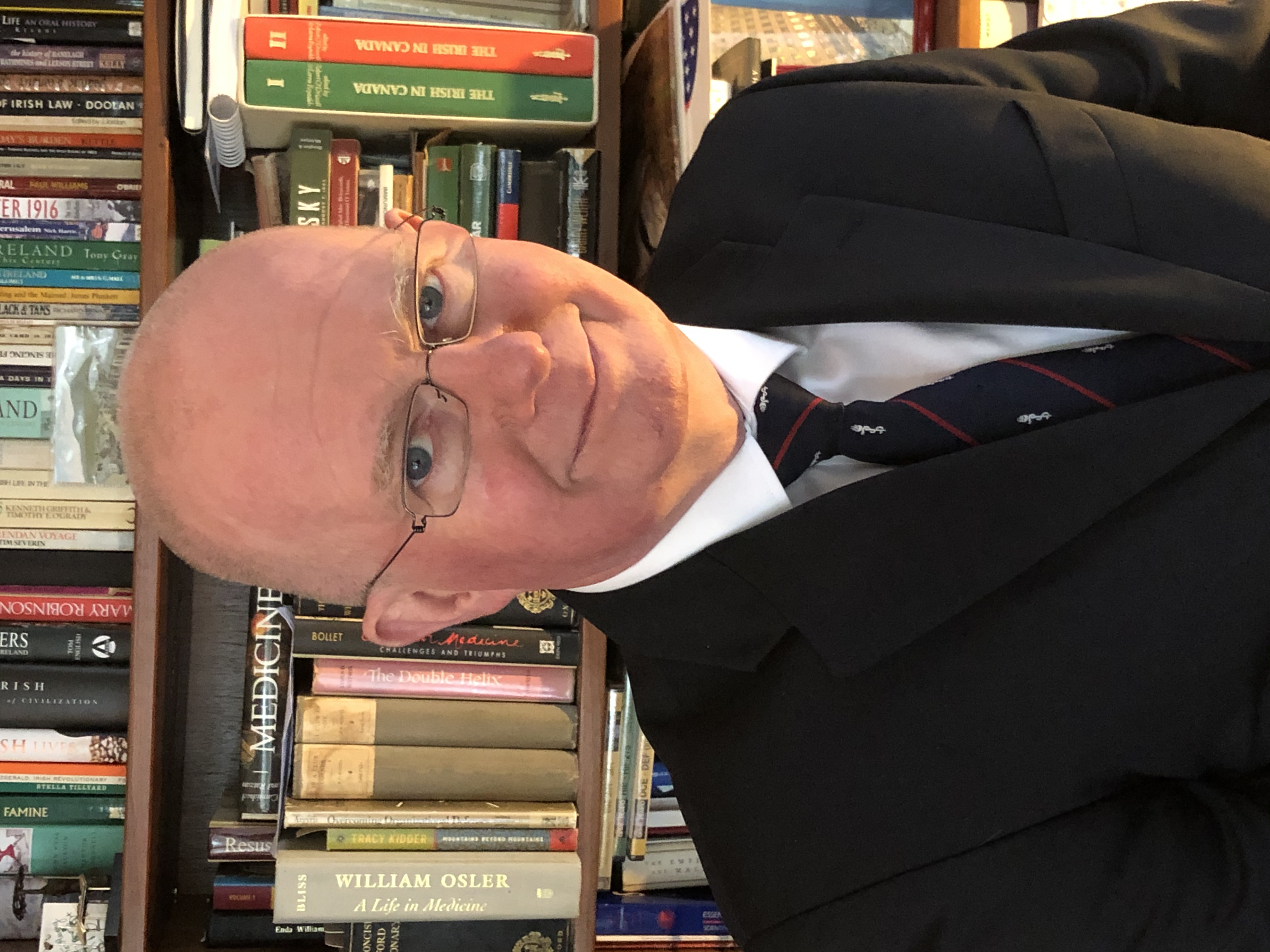 Profile photograph of Vivian McAlister in front of bookshelf