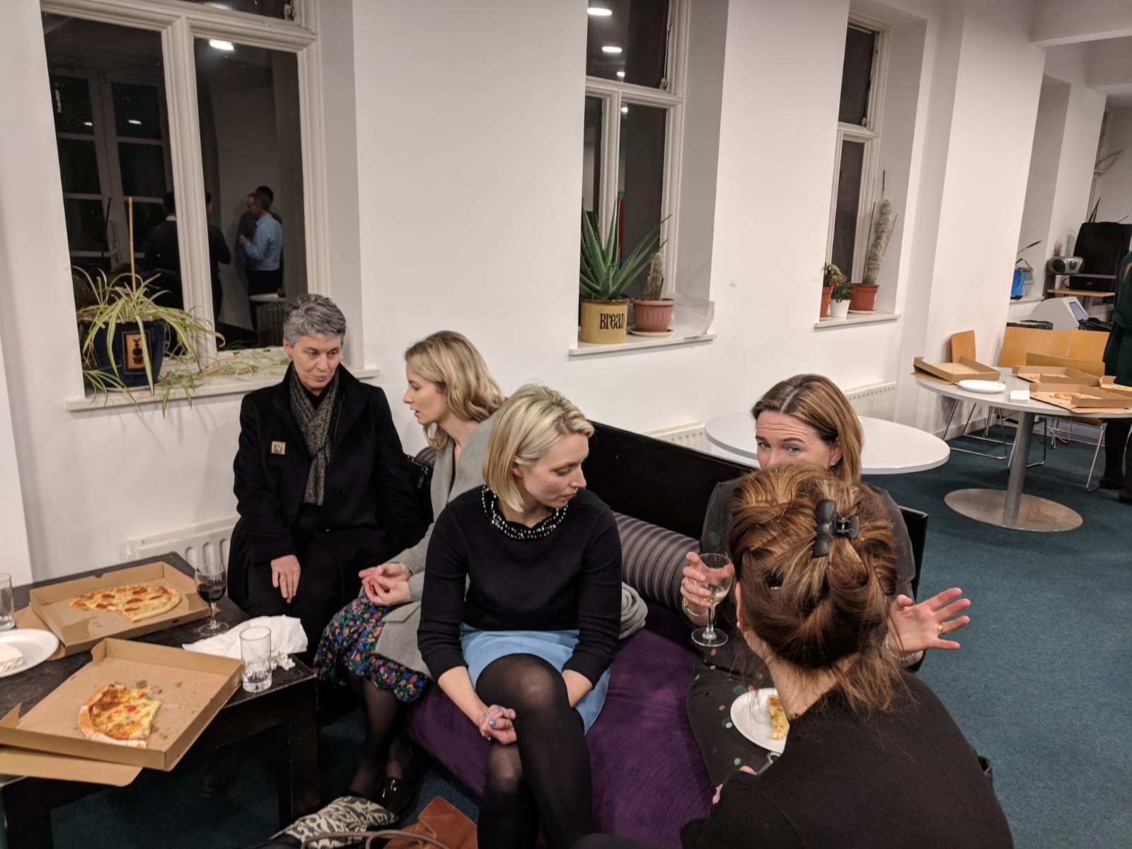 Academics enjoying pizza and wine