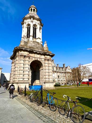 A stone building with bicycles parked in front of it  Description automatically generated with low confidence